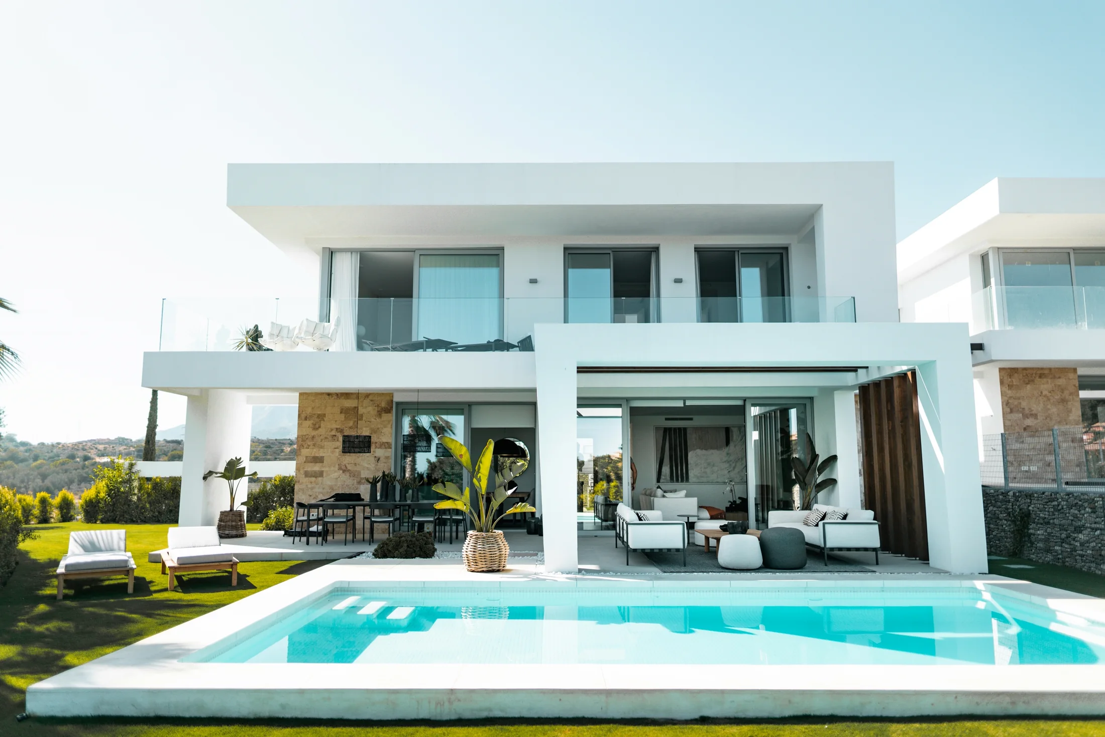 Backyard pool area with surrounding deck, landscaping, and equipment planning space